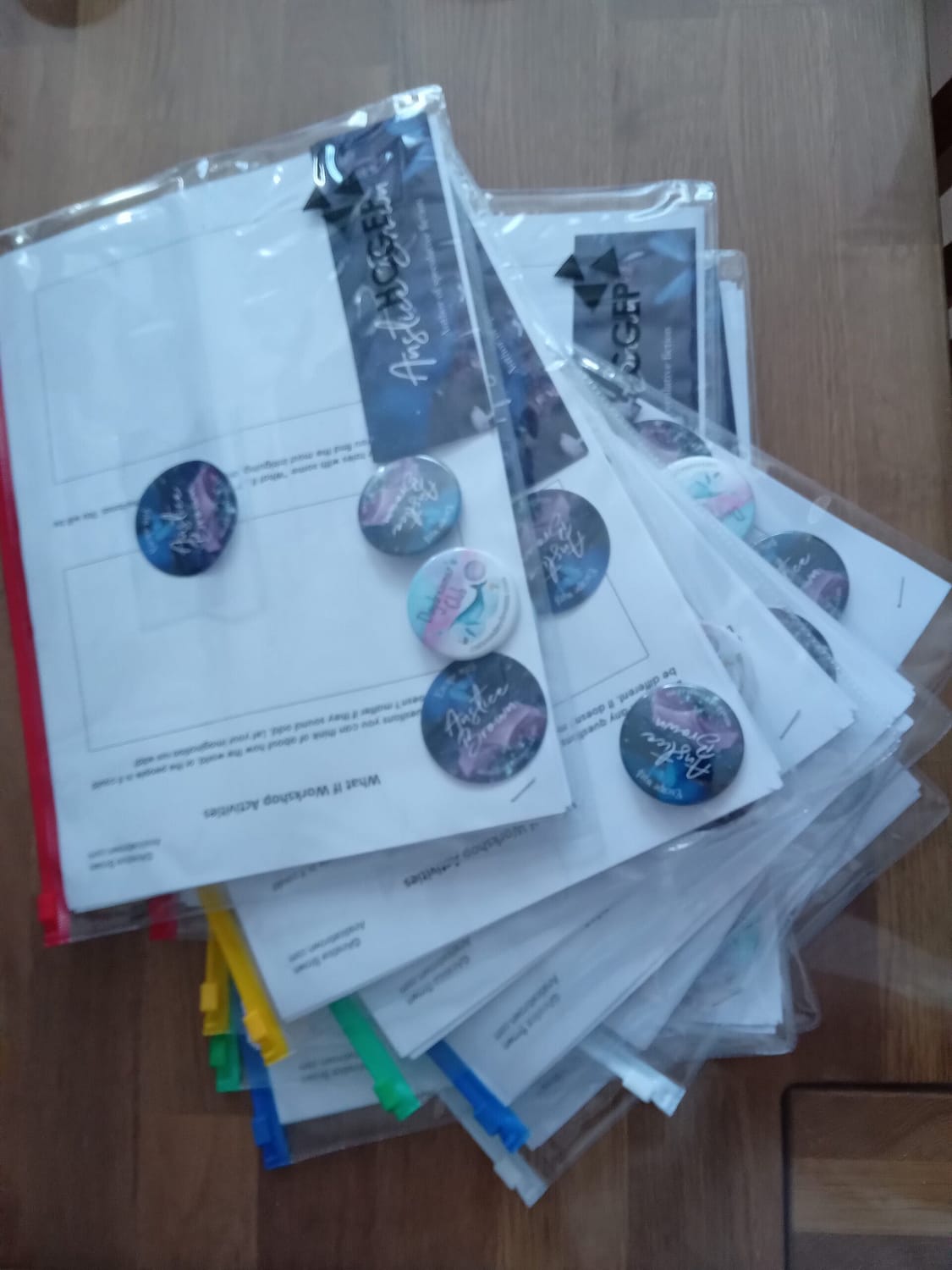 Writing packs for Anstice Brown's What If workshop, filled with story planning resources, pin badges and bookmarks