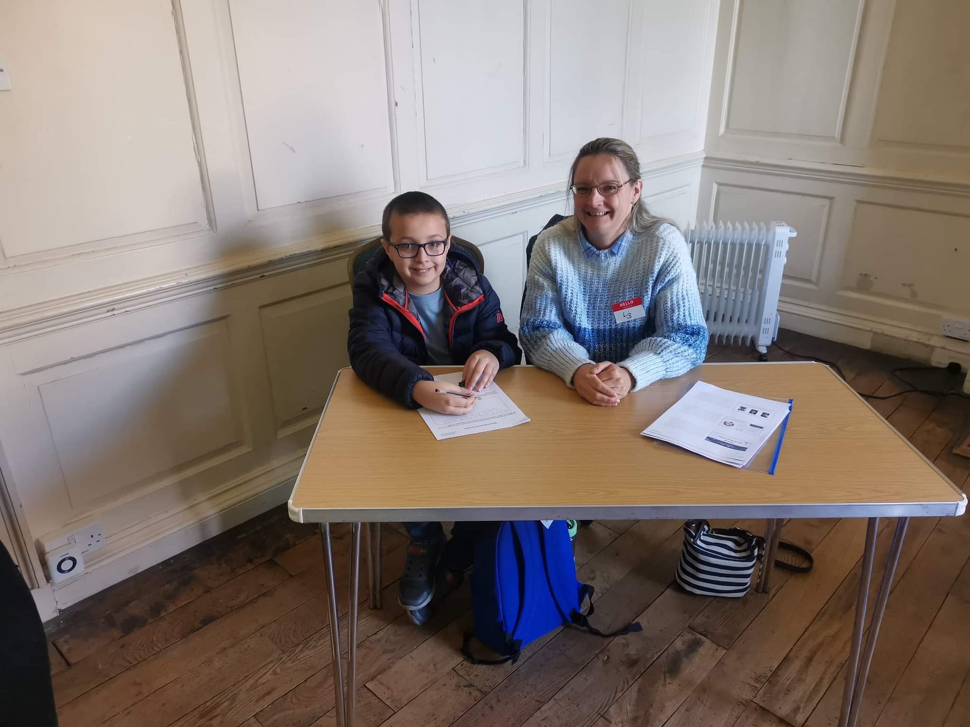 A young boy and his mum attending Anstice Brown's writing workshop
