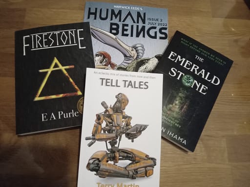 Books I purchased from Boston Book Festival, including Firestone, Human Beings Issue 2, Tell Tales and The Emerald Stone.